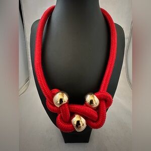 Mika red cord knotted necklace with large gold tone beads